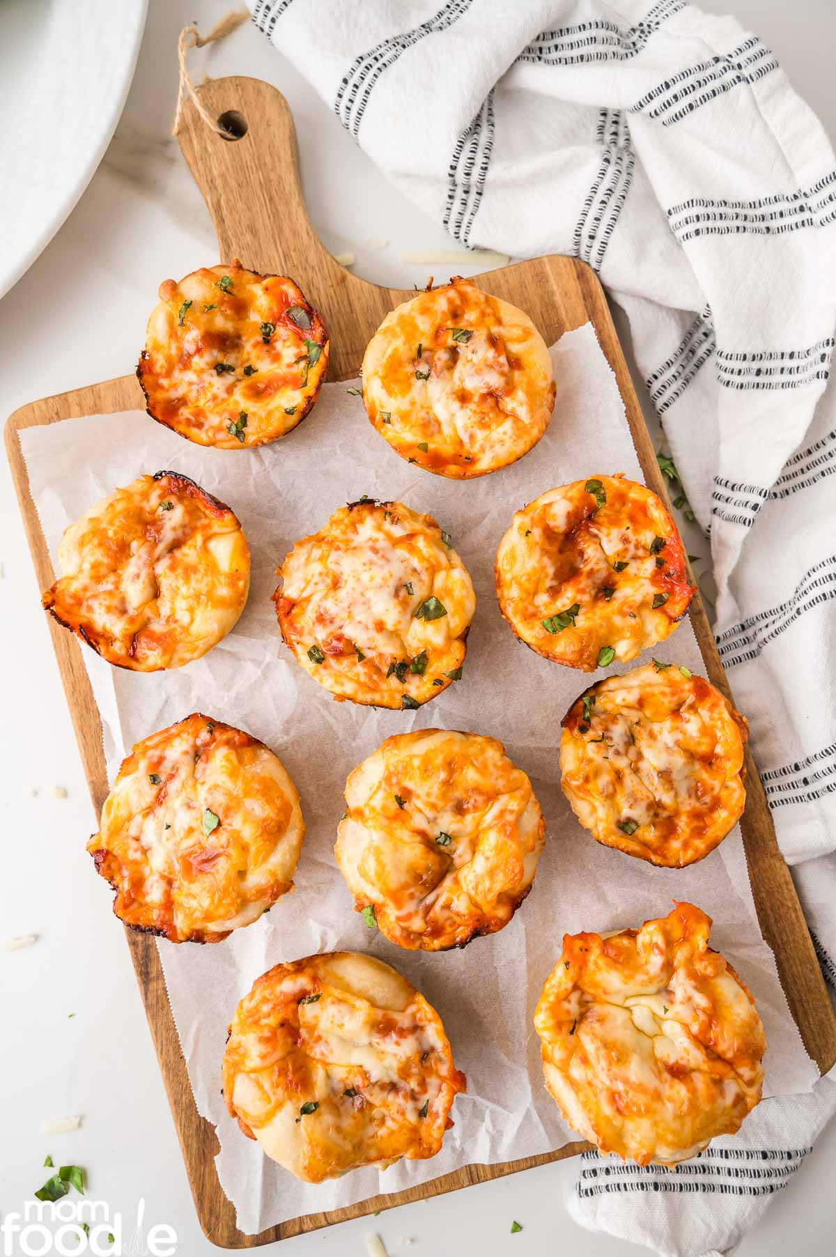 mini pizza muffins on wood board