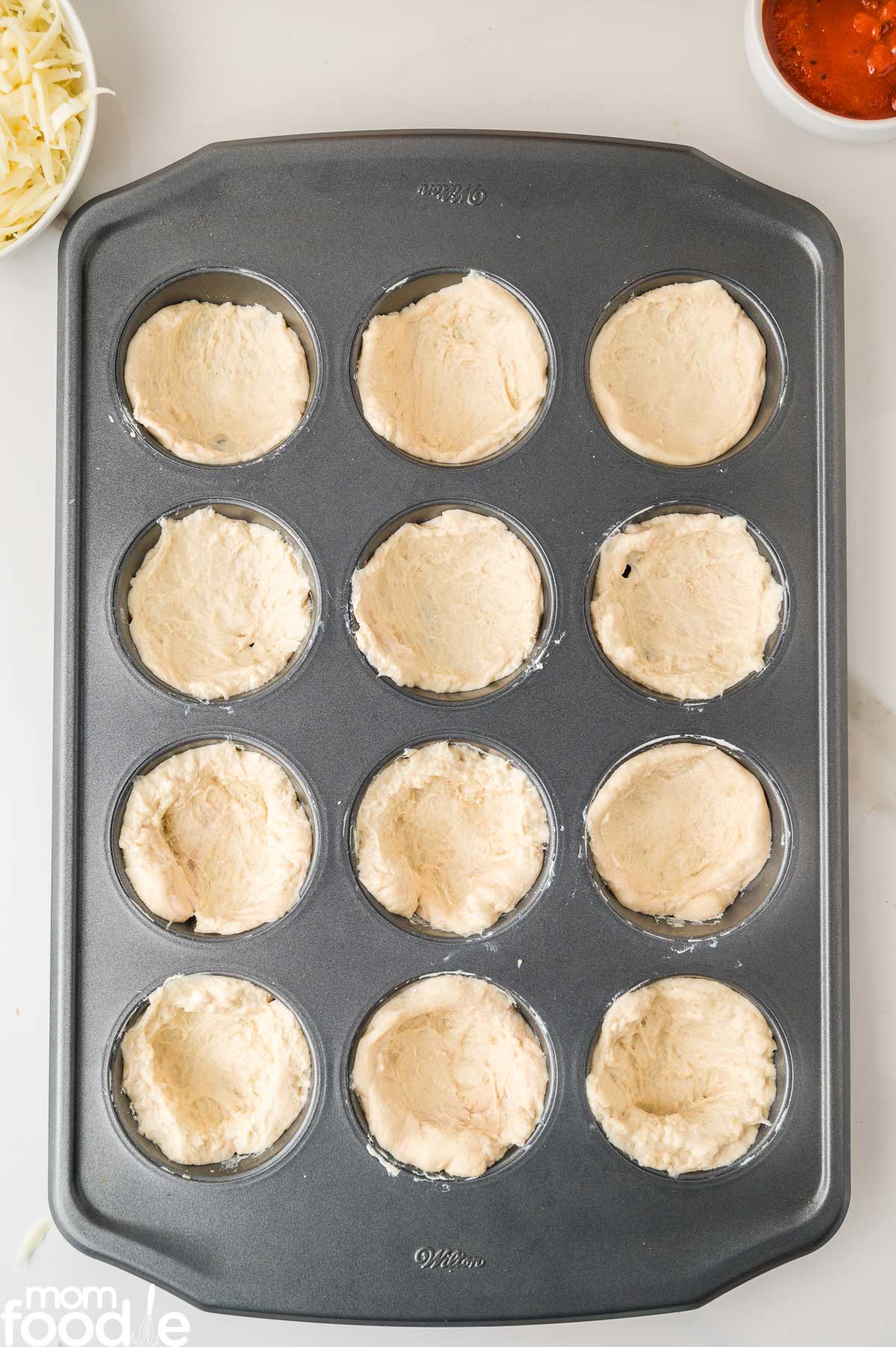 pizza dough in muffin pan
