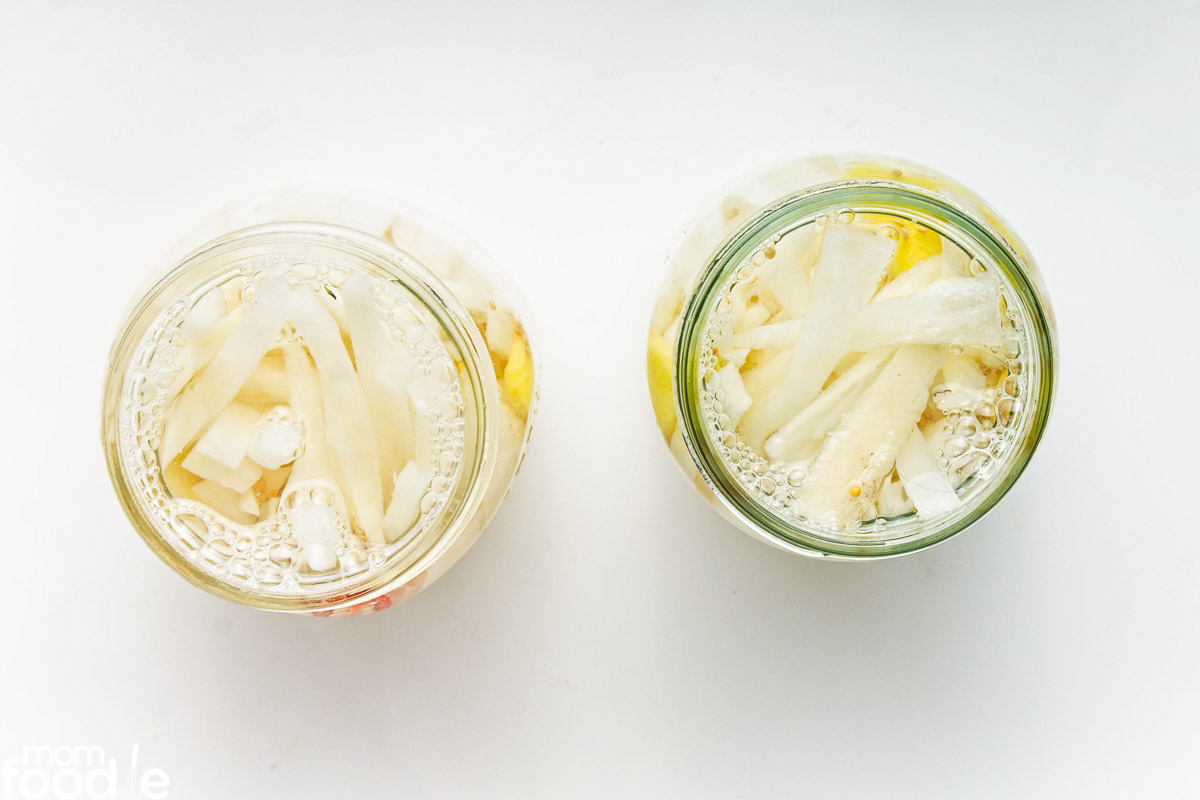 daikon pickles in jar with brine.