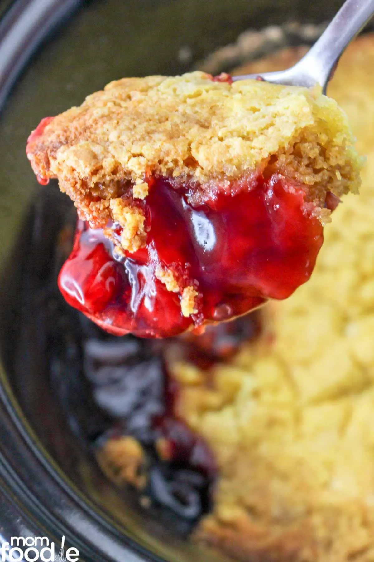 scoop of crock pot cherry dump cake