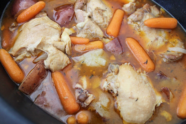 Crockpot Chicken Thighs with Potato and Carrot slow cooking in sauce.