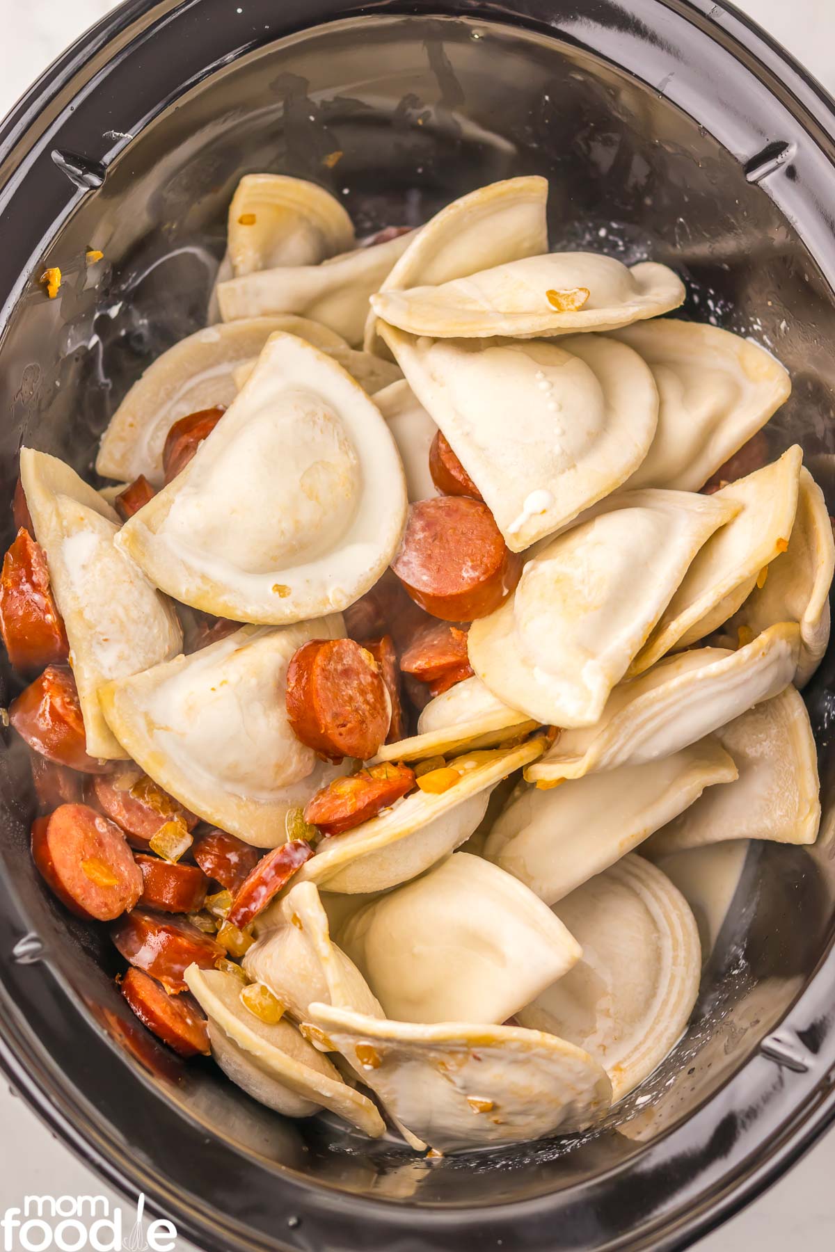pan fried sausage, onions and frozen pierogi in the slow cooker