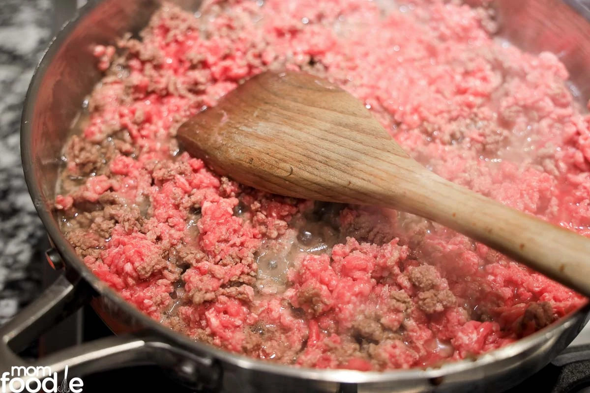 cooking hamburger meat in skillet.