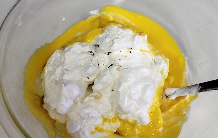  folding egg whites and vanilla seeds into egg yolk