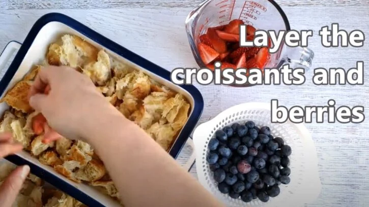 layer sliced berries with torn croissant pieces