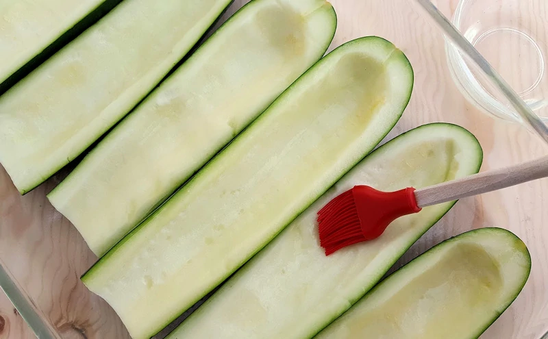 zucchini halves hollowed for stuffing