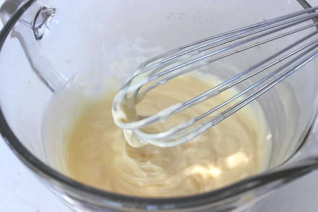 whisking cheesecake filling