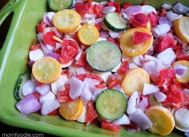 adding vegetables to the chicken ravioli bake