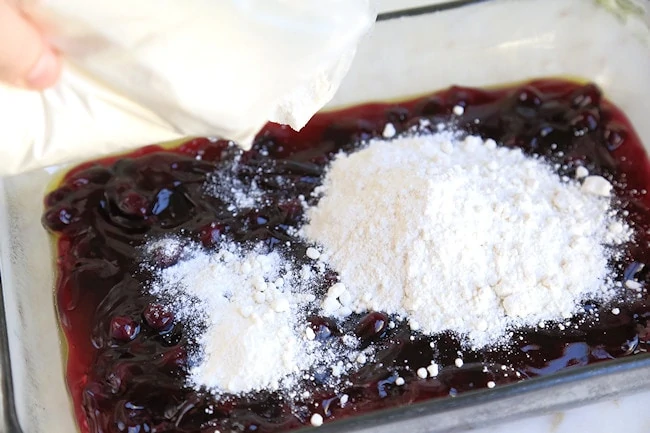 sprinkle the cake mix over the blueberries