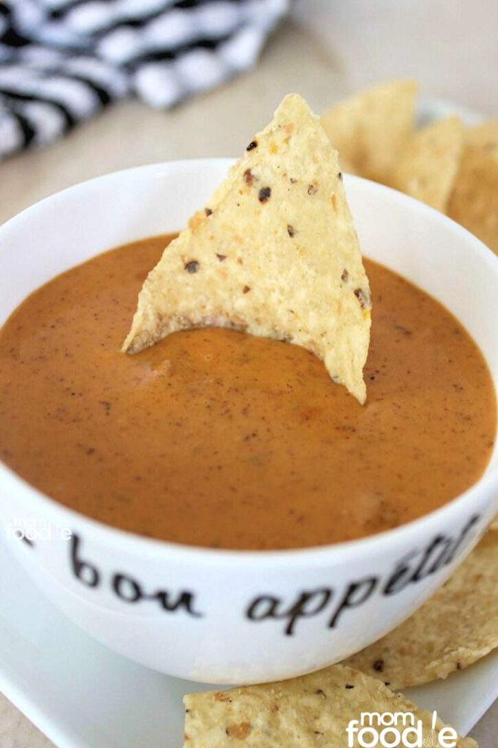 chili's queso dip, copycat of chili's skillet queso recipe shown in a bowl with tortilla chips