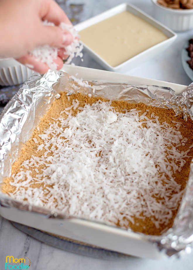 sprinkle the coconut layer over the buttery crumbs.