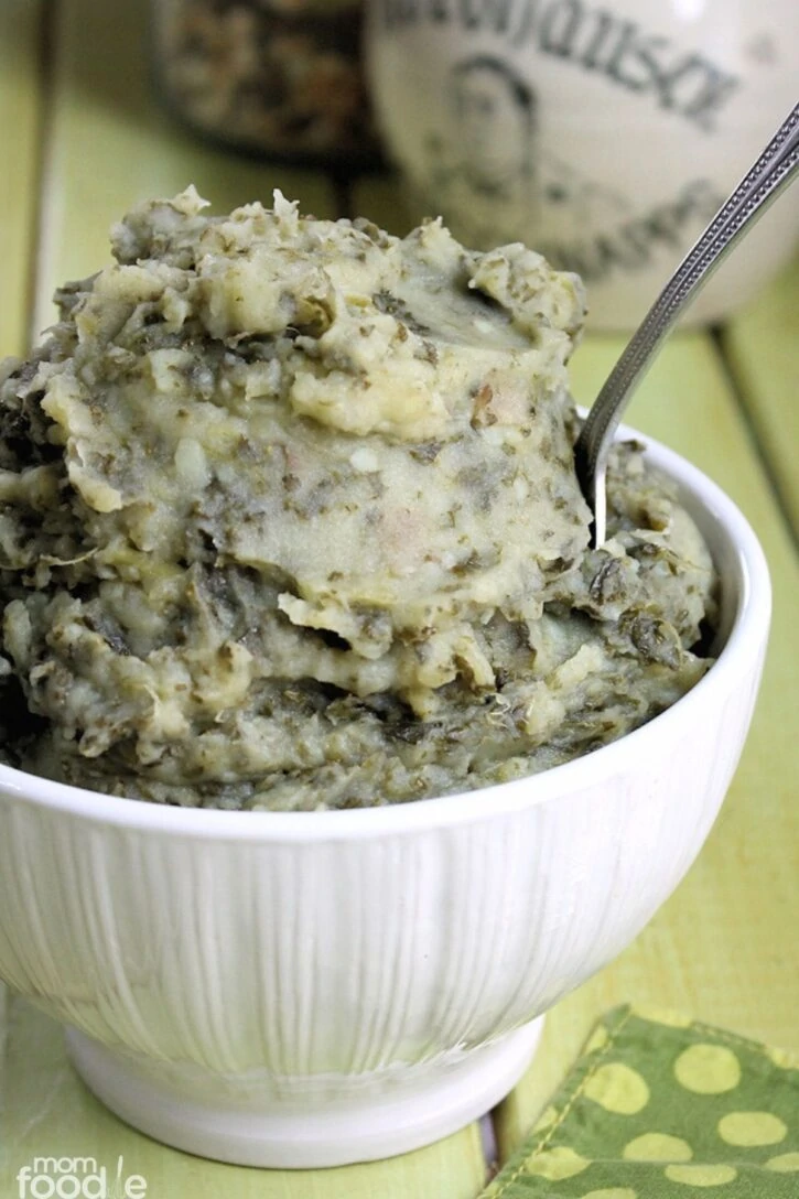 Colcannon recipe with kale for St. Patrick's Day. The tradition Irish side dish is shown in an embossed white bowl.