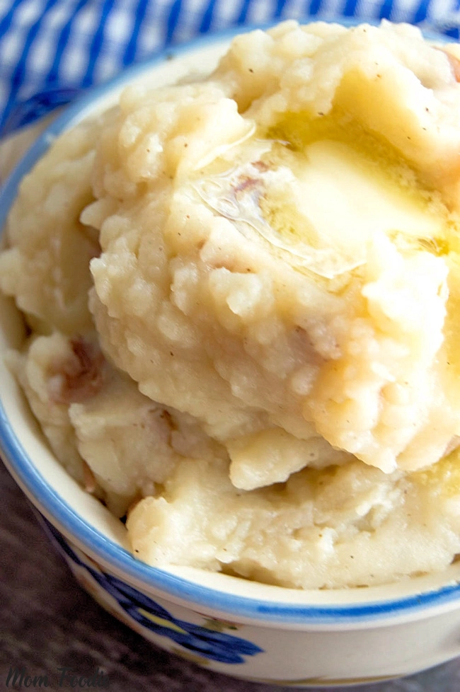 crockpot mashed potatoes in a bowl with melted butter