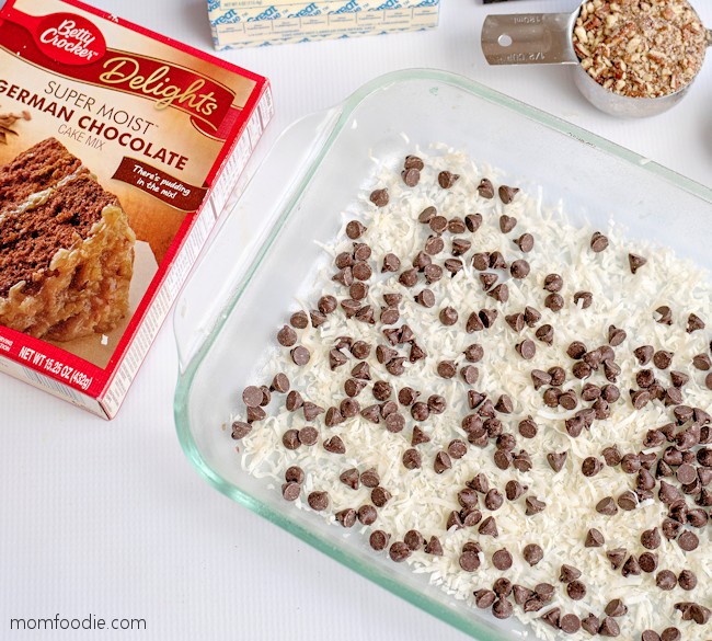 add chocolate chips on top of shredded coconut in the pan