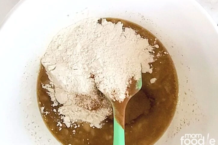 Add dry ingredients: flour baking soda cinnamon to the wet ingredient mixture.