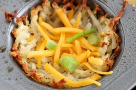 hash browns in muffin tins with cheddar and green onions