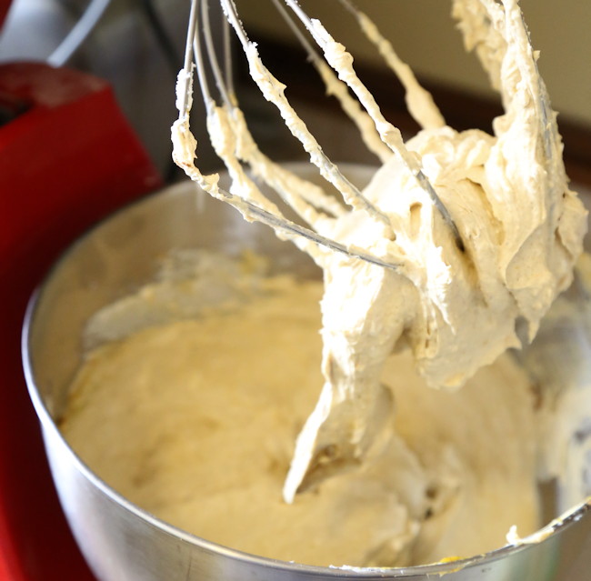 in large bowl beat cream cheese mixture until well combined,  makes keto pumpkin cheesecake batter with pumpkin spice. shown sticking to mixer whisk.