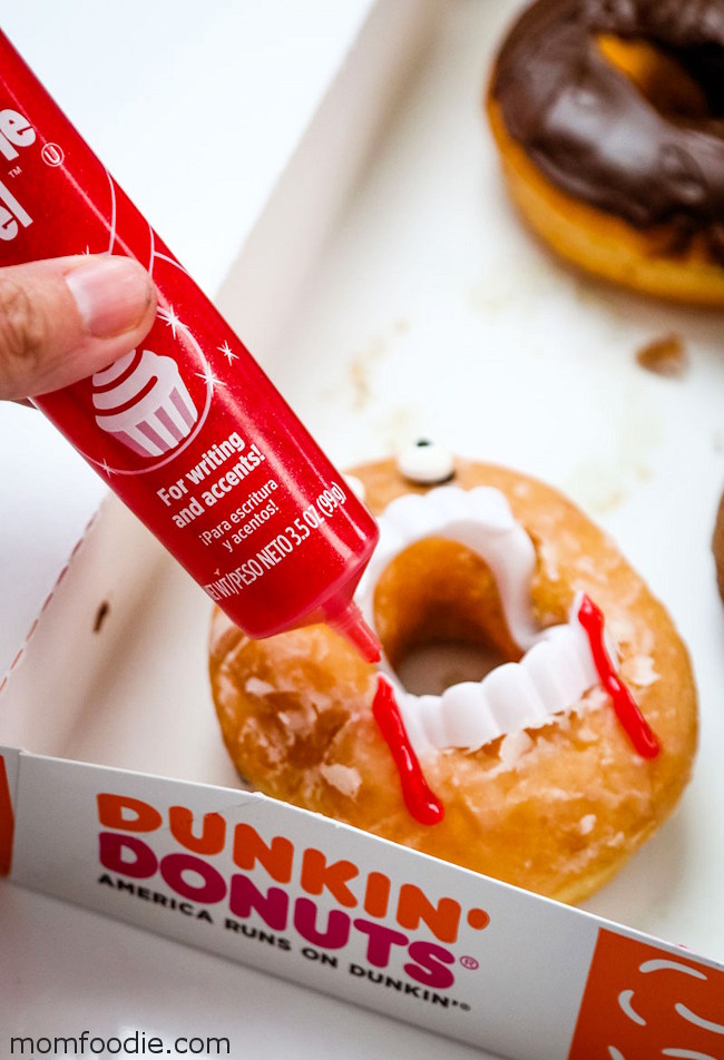 making vampire donuts, applying blood icing