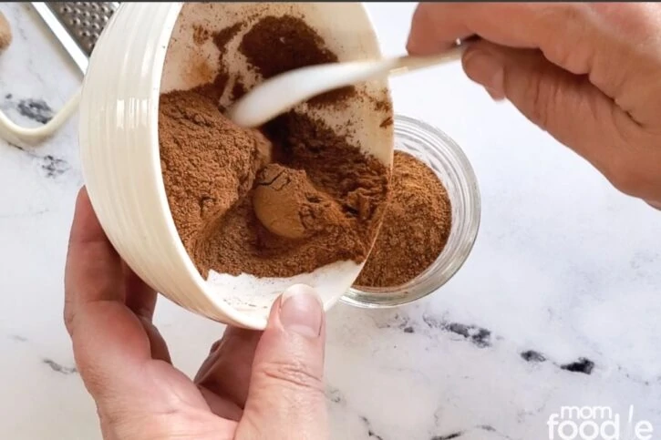 pouring spices into mason jar.