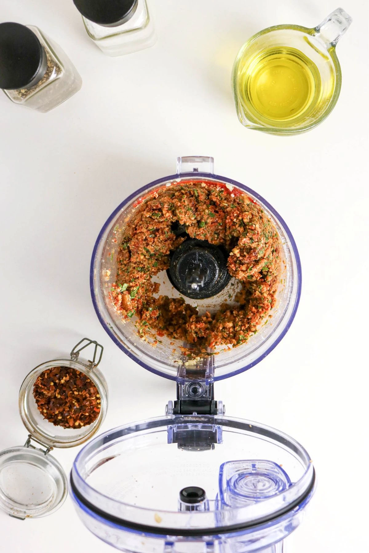 pulsing pesto ingredients in food processor