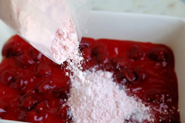 strawberry cake mix spread over filling