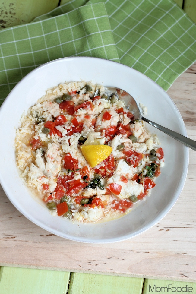 keto chicken foil packets with cauliflower rice, tomato, capers and lemon in serving dish