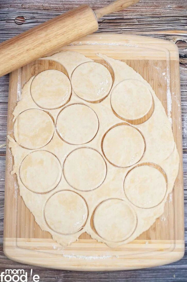roll out pie dough and cut out pastry circles