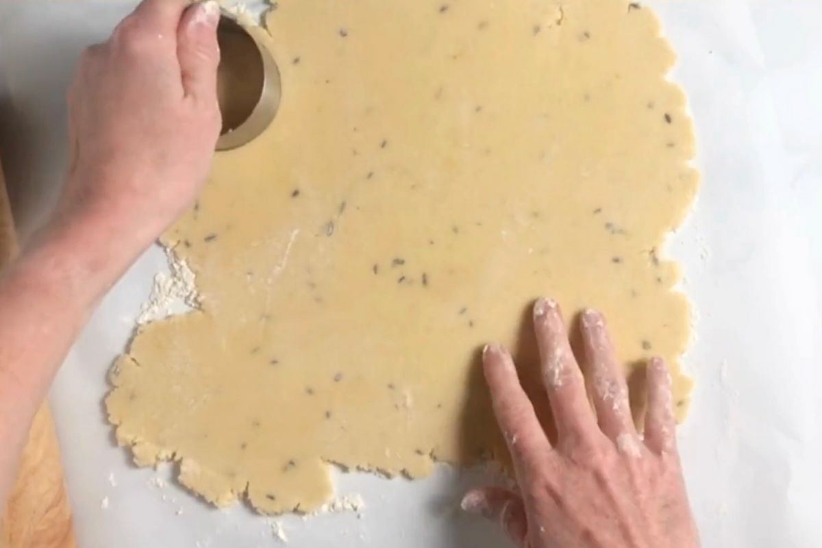 using cookie cutter on rolled out cookie dough